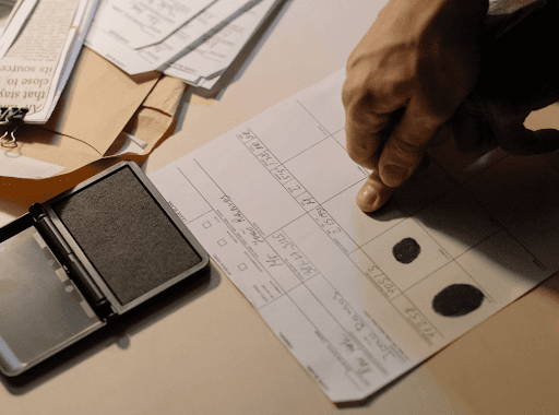 Close up of a person capturing their fingerprints on a document.